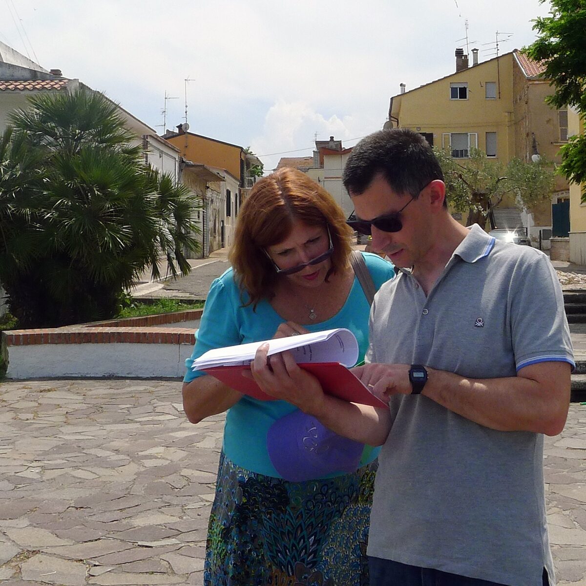 Emidio reading the genealogy report with a client during a tour. 